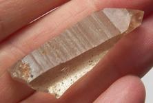 Photo of tangerine pink Lemurian Quartz crystal, very powerful, planted seed by ancient Lemurian civilization