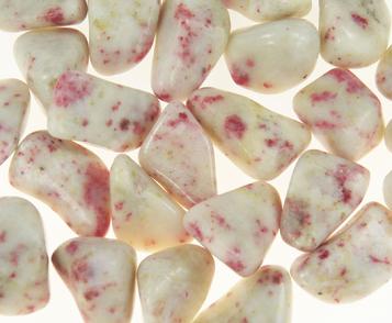 Photo of Cinnabite tumbled stones from Peru, which is a combination of Scapolite and Cinnabar used for metaphysical crystal healing