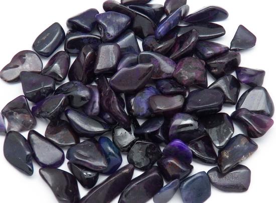 Photo of bulk tumbled purple sugilite from Wessels mine in South Africa